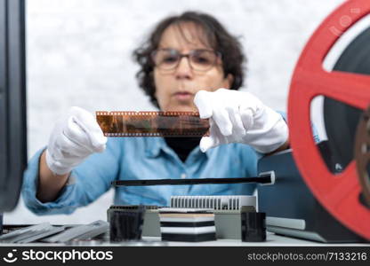 a woman photographer looking at negatif film