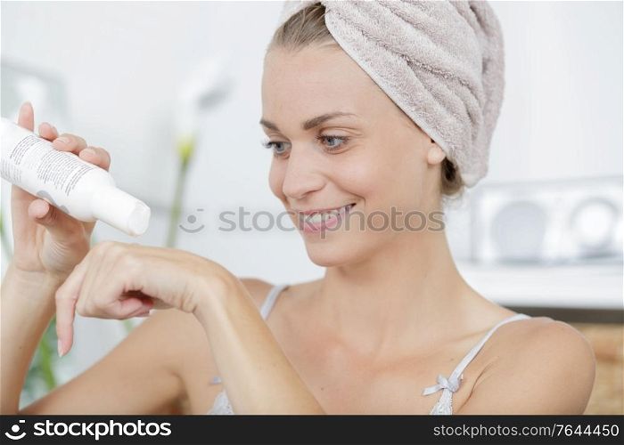 a woman puts cream on her hands