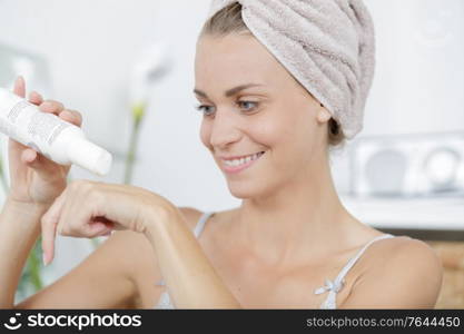 a woman puts cream on her hands