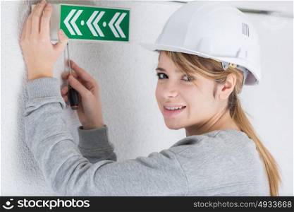 a woman putting emergency signs
