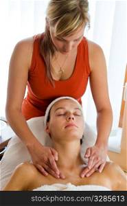 A woman receives a relaxing massage from a beauty therapist