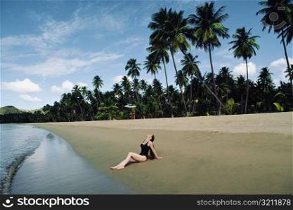A woman relaxing on a beach, Puerto Rico