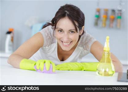 a woman scrubbing work surface