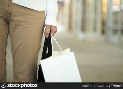 A woman shopping, carrying a bag