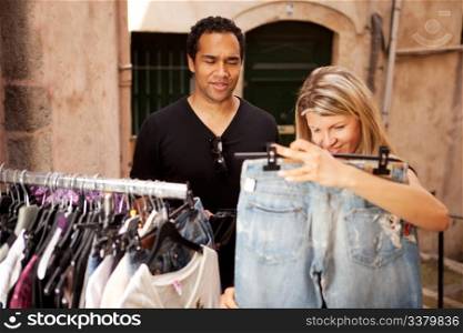 A woman shopping for expensive clothes, shallow depth of field - focus on man