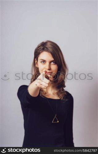 A woman shows a finger forward
