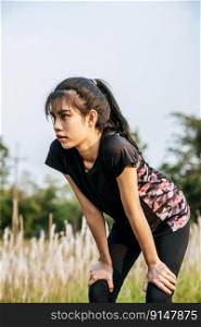 A woman standing Relax after exercise on the road. Selective focus.