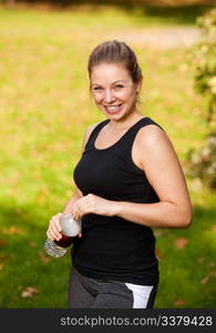 A woman taking a break from exercising in the park