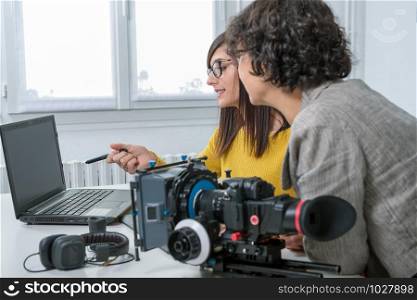 a woman video editor and young assistant using graphic tablet