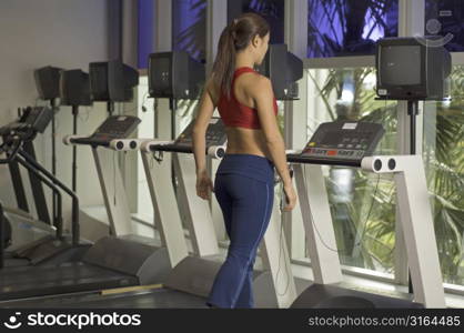 A woman walks on a treadmill