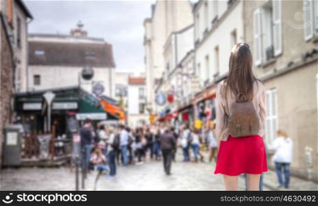 A woman walks through the streets of Paris
