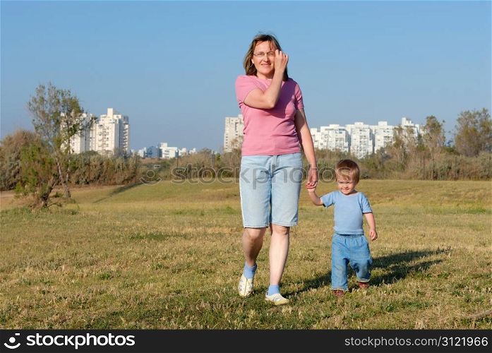 A woman walks with her daughter in the evening in the park of the city of Ashqelon
