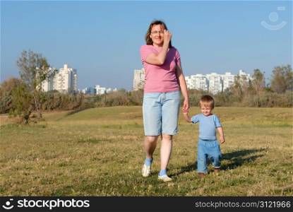 A woman walks with her daughter in the evening in the park of the city of Ashqelon