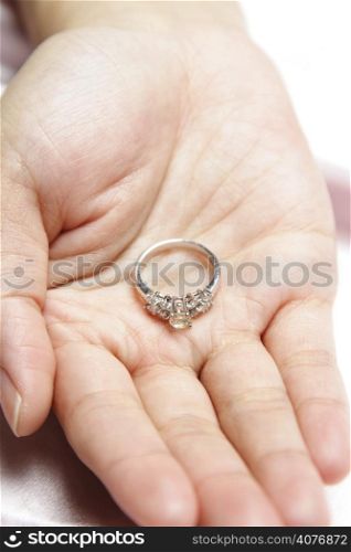 A woman with a diamond engagement ring on her hand