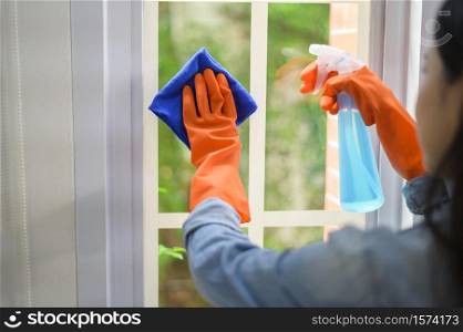 A woman with cleaning gloves using alcohol spray sanitiser to cleaning house, healthy and medical, covid-19 protection at home concept .. A woman with cleaning gloves using alcohol spray sanitiser to cleaning house, healthy and medical, covid-19 protection at home concept