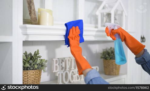 A woman with cleaning gloves using alcohol spray sanitiser to cleaning house, healthy and medical, covid-19 protection at home concept .. A woman with cleaning gloves using alcohol spray sanitiser to cleaning house, healthy and medical, covid-19 protection at home concept