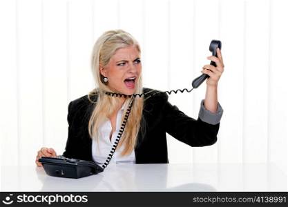 a woman with multiple phone sits in the office and under stress.