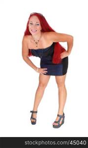 A woman with red hair wearing a jeans dress standing from the front,isolated for white background.