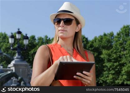a woman with tablet outdoor