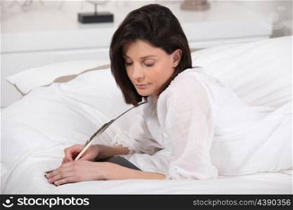 a woman writing diaries with a feather