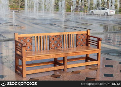 A wooden bench near the fountain