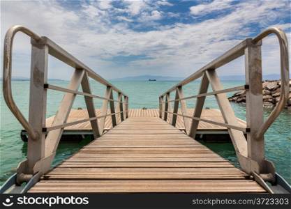 A wooden deck with metal railing on the shores of the Red sea