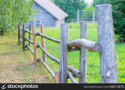 a wooden fence and old rural house in village