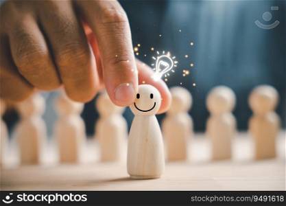 A wooden figure holds a glowing light bulb, representing creative thinking and inspiration. Leadership and coordination foster teamwork, allowing for the sharing and creation of innovative ideas.