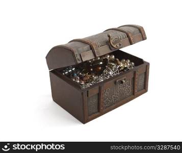 A wooden patterned casket filled with jewelry half open. Isolated on white background
