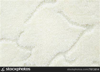a woolen white carpet with a relief pattern