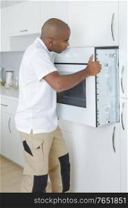 a worker fitting an oven