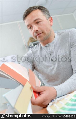 a worker selecting some tiles