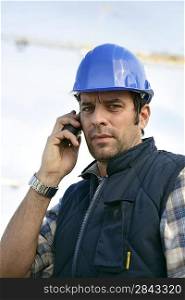 a workman at phone on a building site