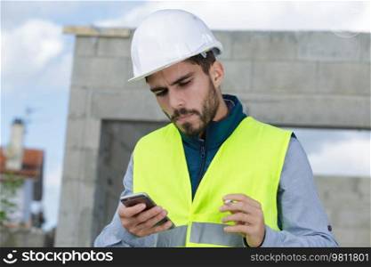 a workman having text conversation
