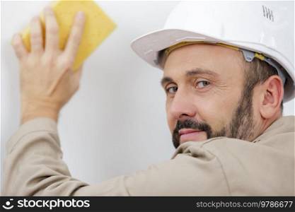 a workman washing a wall