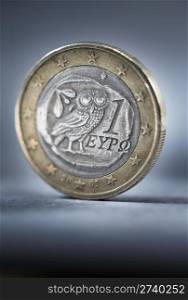 A worn and dirty Greek Euro coin. Short depth of field.