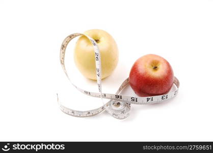 A yellow and a red apple with a white measuring tape around onwhite background.