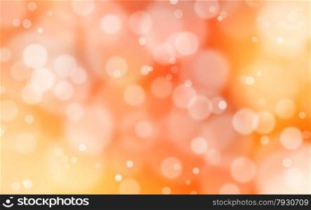 A yellow and red bokeh background with white flares