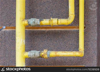 A yellow gas tube outside of a house to canalize the soft energy at home.