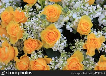 a yellow rose bouquet with white syringas