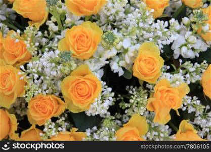 a yellow rose bouquet with white syringas