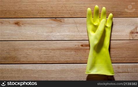 a yellow rubber wiping glove on a wooden floor. texture, wallpaper.