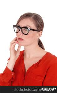 A young afraid looking woman with her hands on her face wearingblack glasses standing isolated for white background