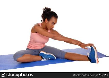 A young african american girl sitting on a yoga mat, stretching her body,for fitness, isolated for white background.