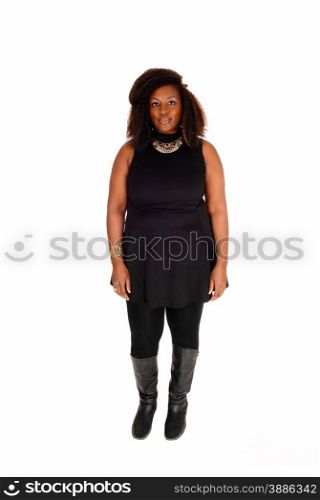 A young African American woman in black tights and short dress withcurly brown hair standing isolated for white background.