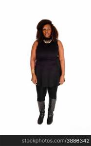 A young African American woman in black tights and short dress withcurly brown hair standing isolated for white background.