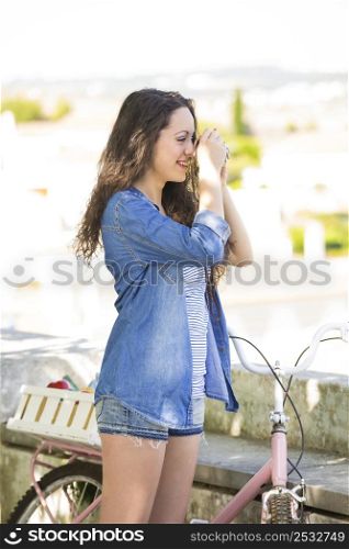 A young and beautiful female tourist taking picture
