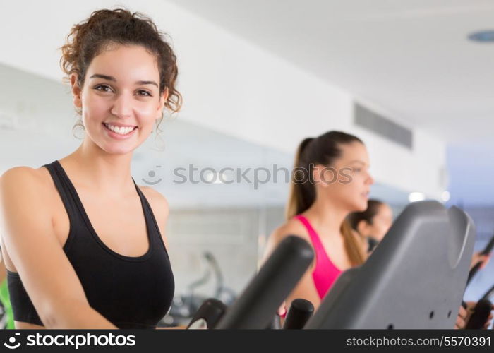 A young and beautiful woman working out at the gym