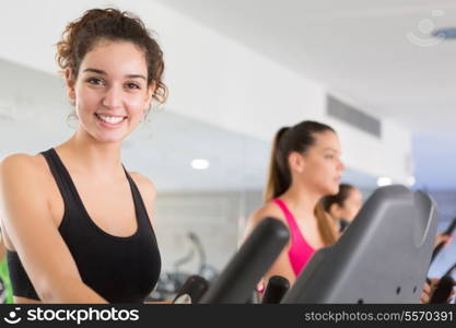 A young and beautiful woman working out at the gym