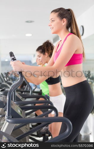 A young and beautiful woman working out at the gym